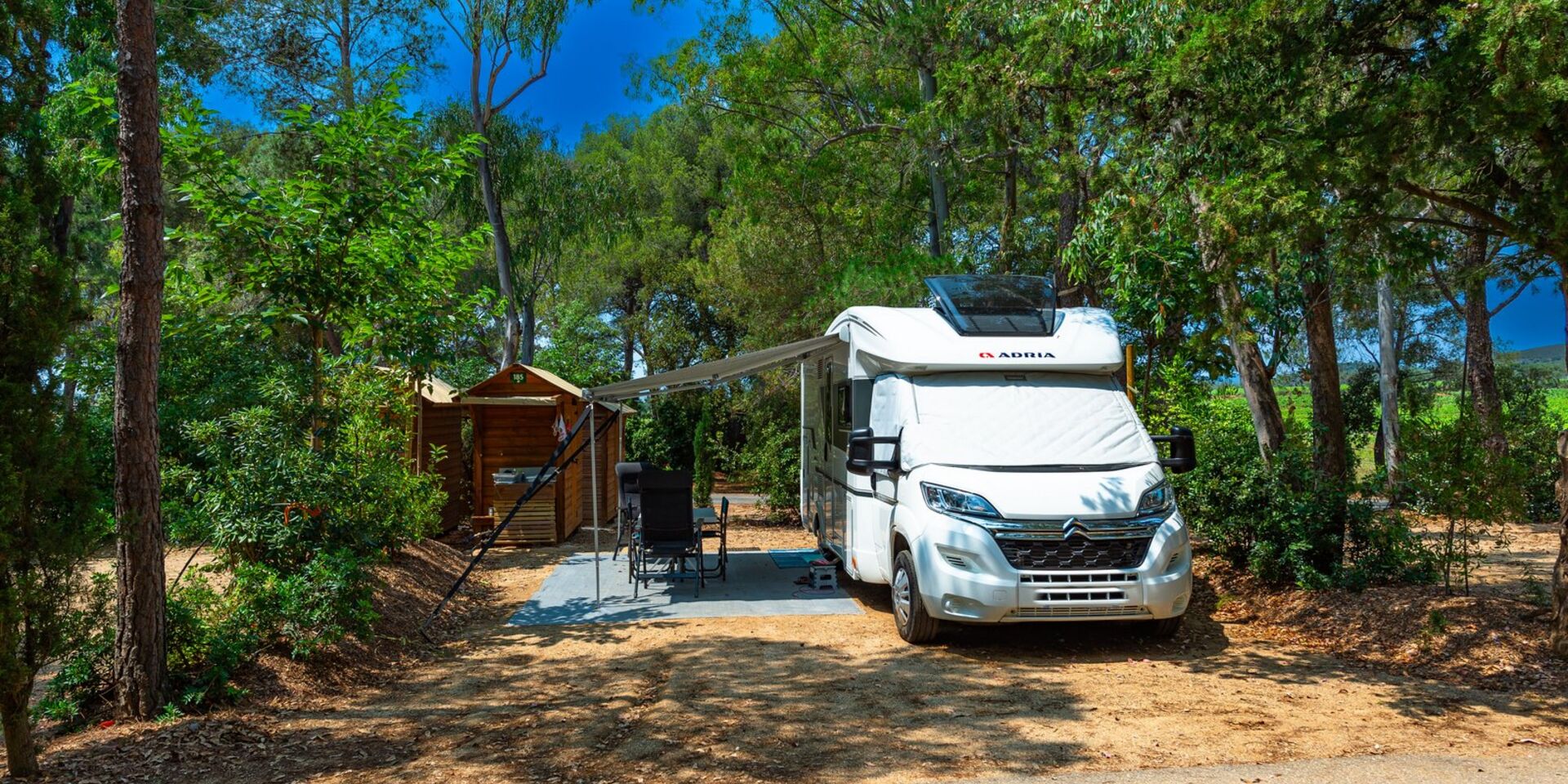 Staanplaats met eigen sanitaire voorzieningen op een schaduwrijke camping